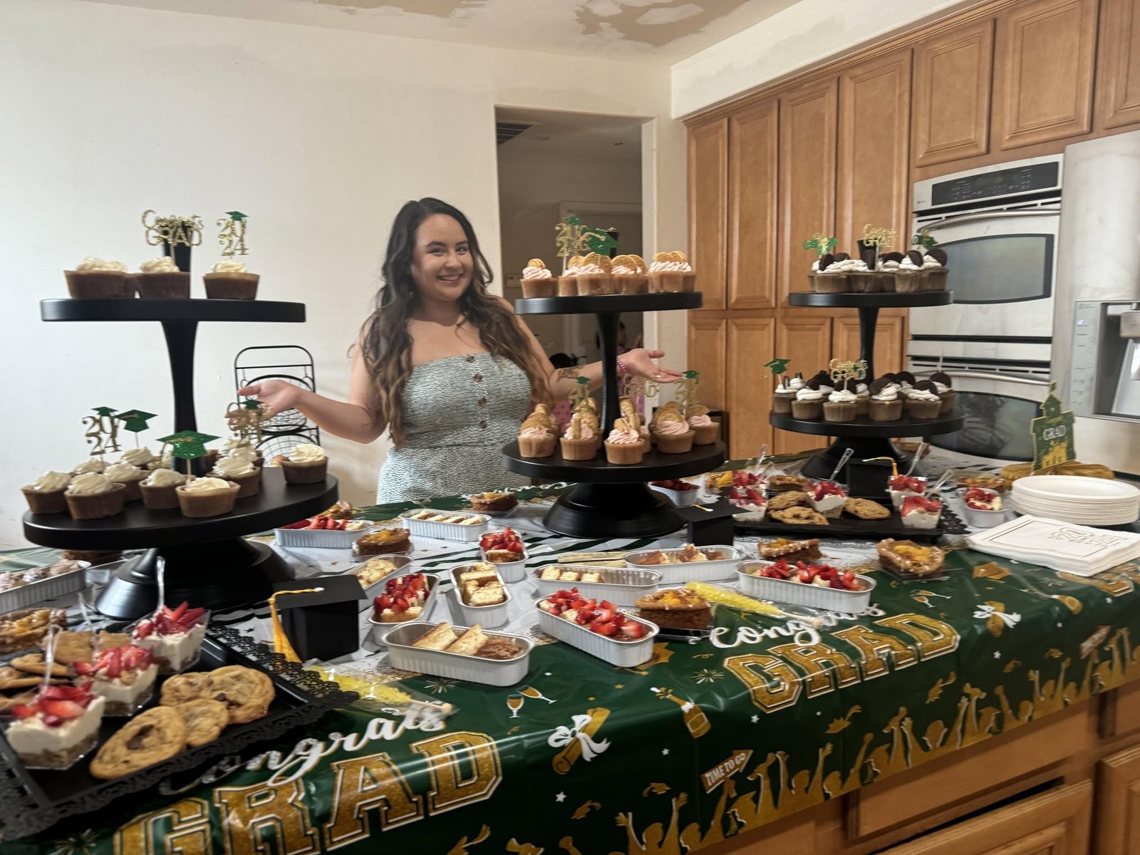 The baker behind Bake Me Happy with a full spread of from-scratch pastries