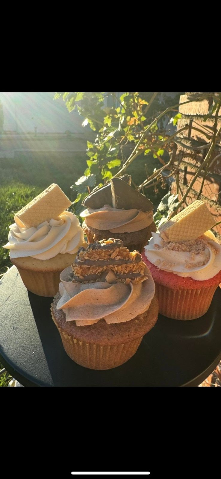 Gourmet cupcakes piled high with buttercream